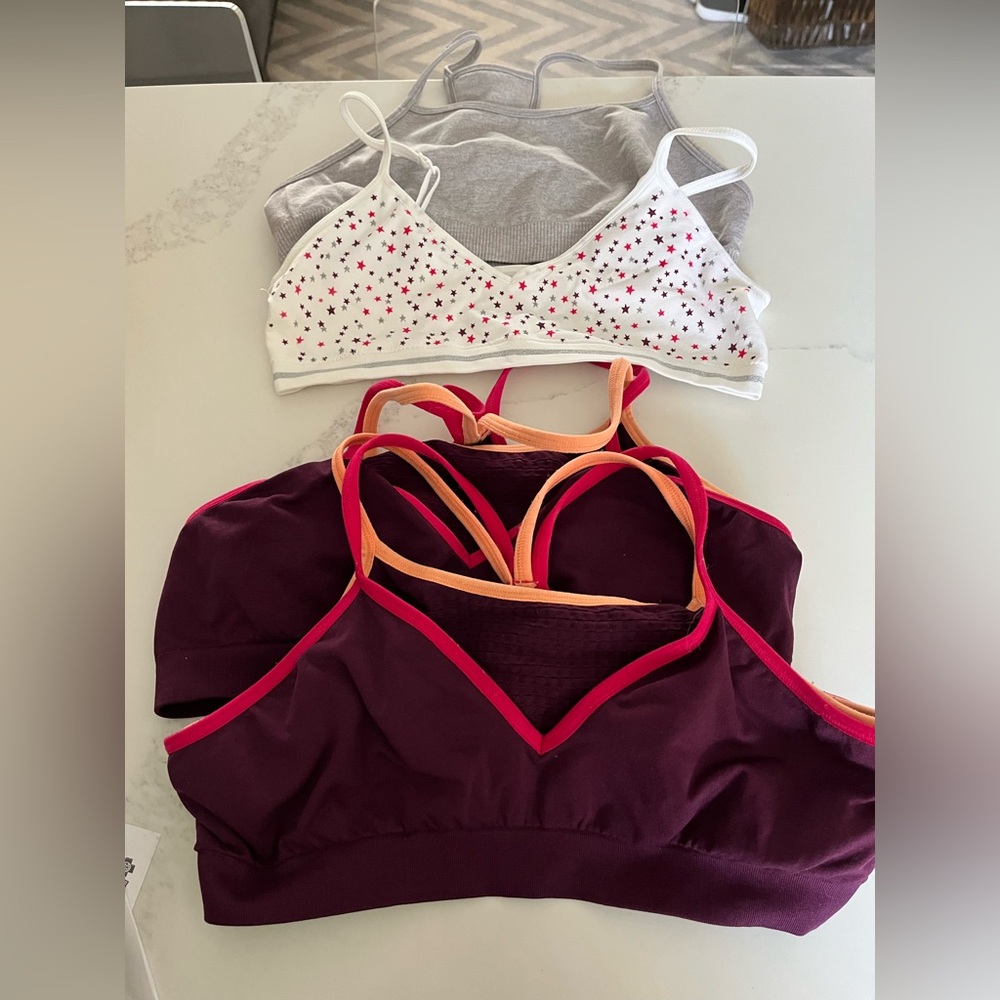 Four girls size xl (approx size 12-14) bras.  Art class, athleta & hanes.